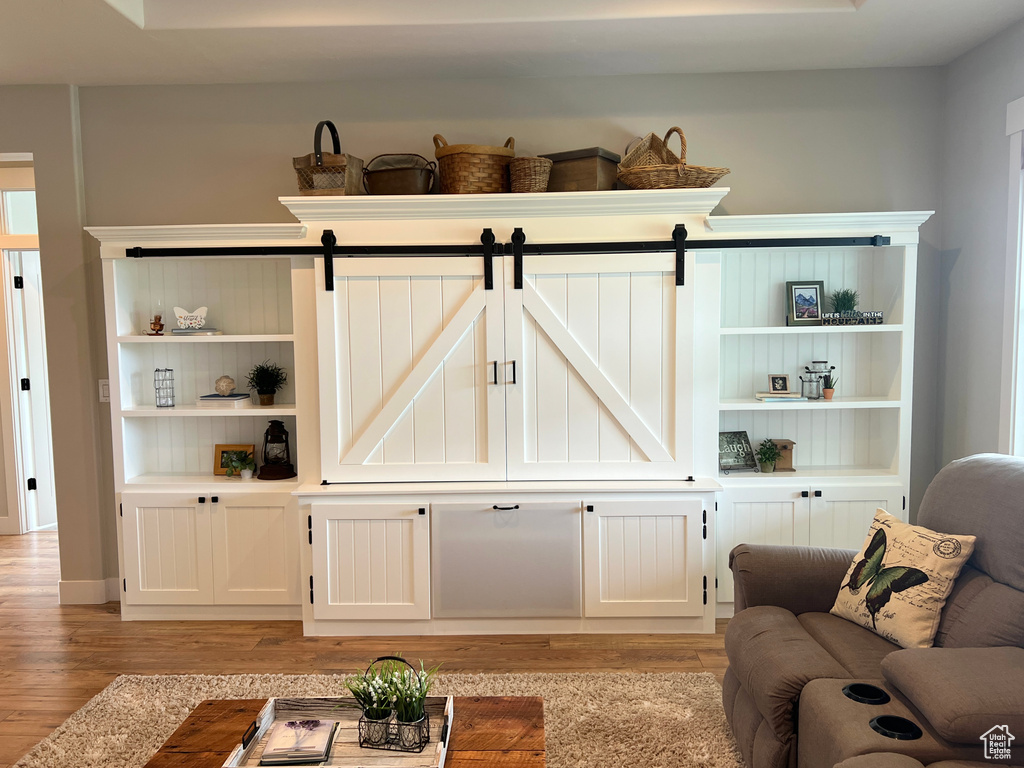 Living area featuring light wood-style flooring and a barn door