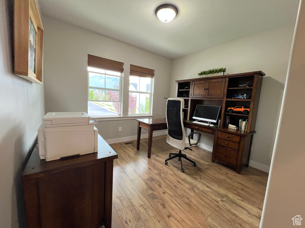 Office featuring light wood-style flooring and baseboards