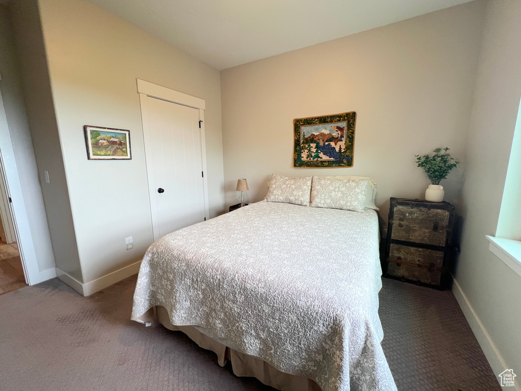 Carpeted bedroom with baseboards