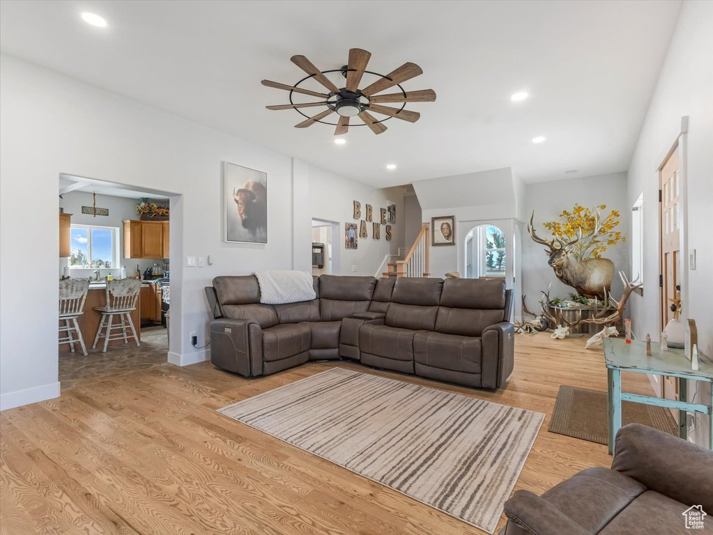 Living area featuring ceiling fan, stairway, light wood-style flooring, and recessed lighting