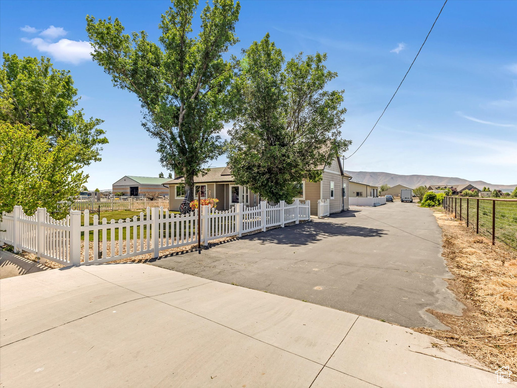 View of front of house featuring a fenced front yard and driveway