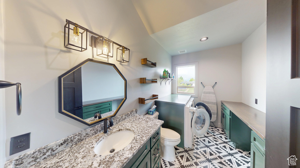 Bathroom featuring vanity, toilet, tile patterned flooring, and recessed lighting