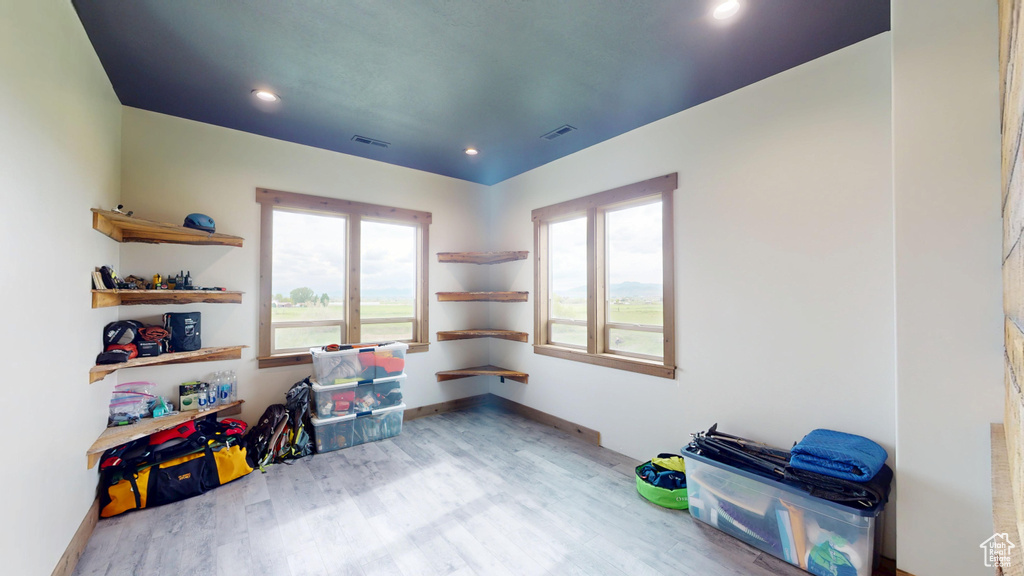 Rec room featuring plenty of natural light, wood finished floors, recessed lighting, and baseboards
