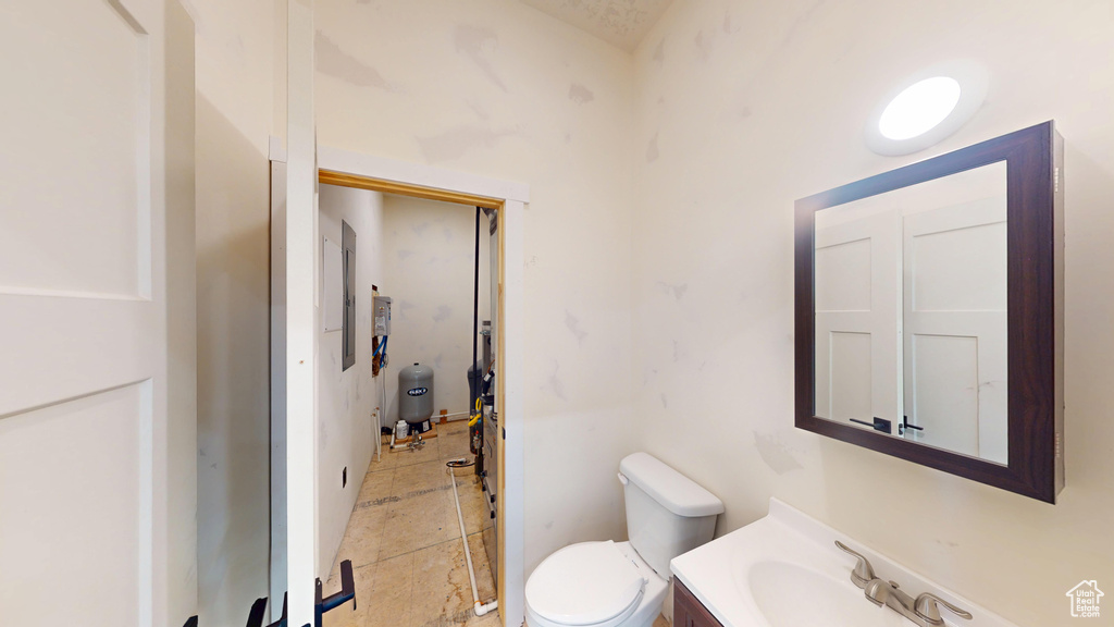Bathroom featuring toilet, vanity, and electric panel