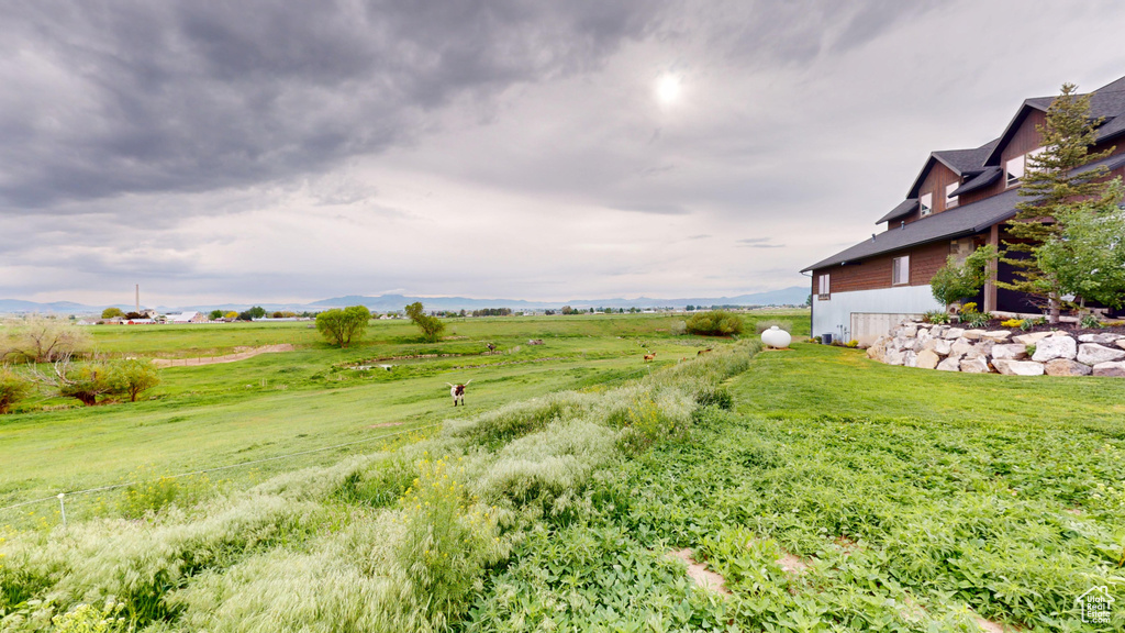 View of yard with a rural view