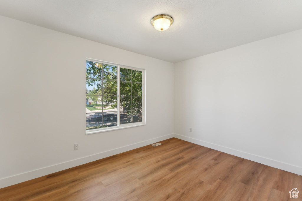 Empty room featuring light wood finished floors and baseboards