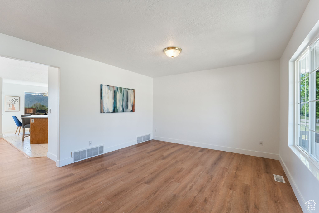 Spare room with light wood finished floors and baseboards