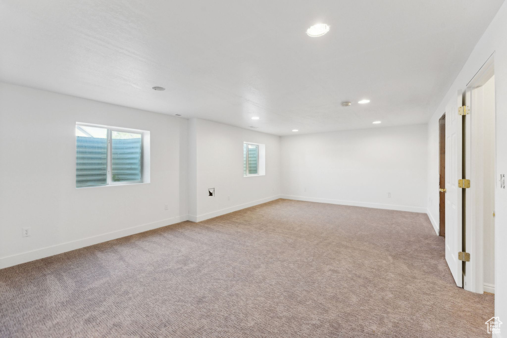 Empty room with carpet flooring, recessed lighting, and baseboards