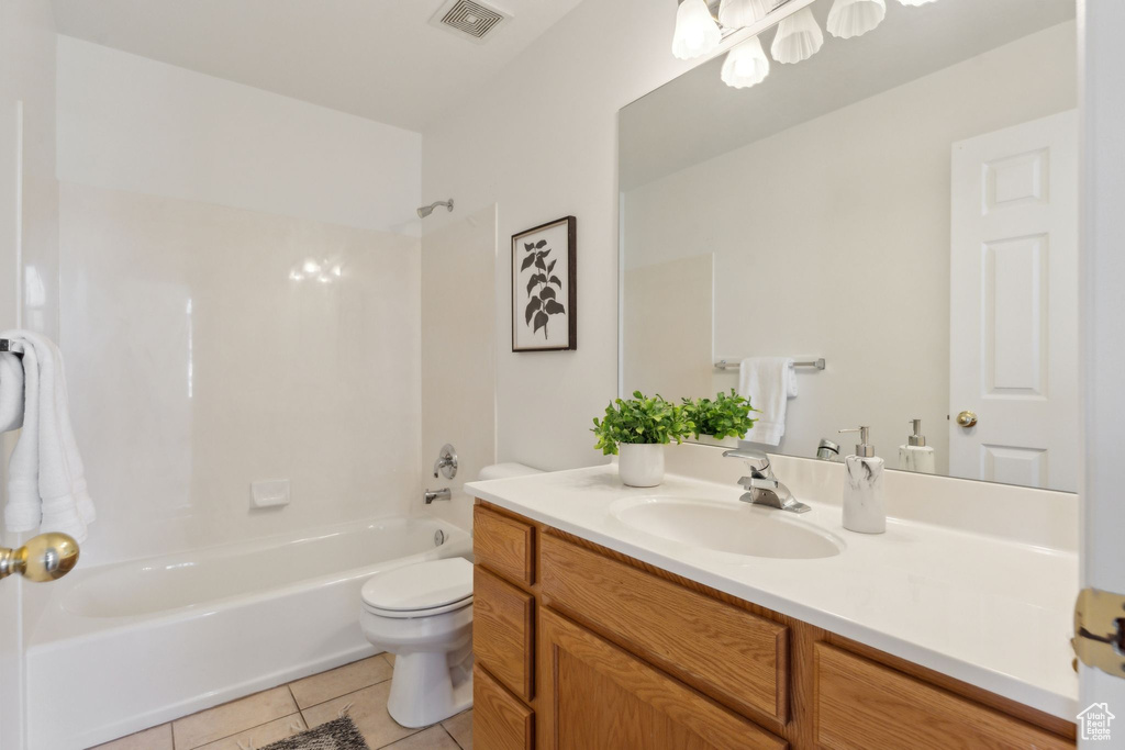 Bathroom featuring vanity, tile patterned flooring, shower / tub combination, and toilet