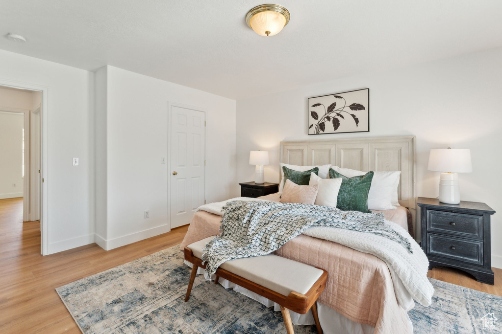 Bedroom featuring light wood-style flooring and baseboards