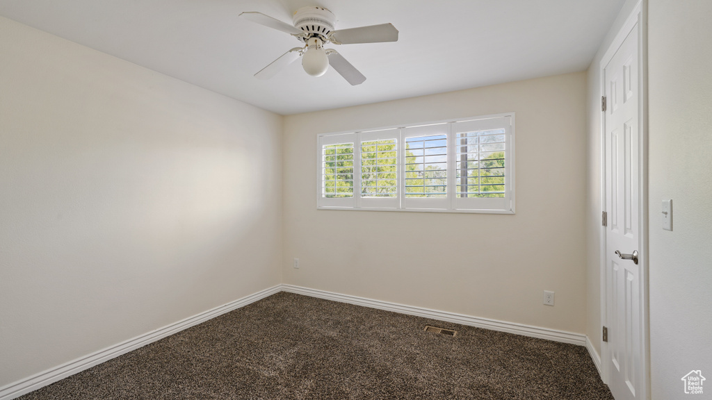 Unfurnished room with carpet flooring, baseboards, and ceiling fan