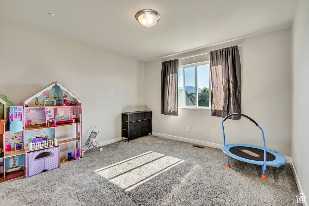 Game room featuring carpet flooring and baseboards