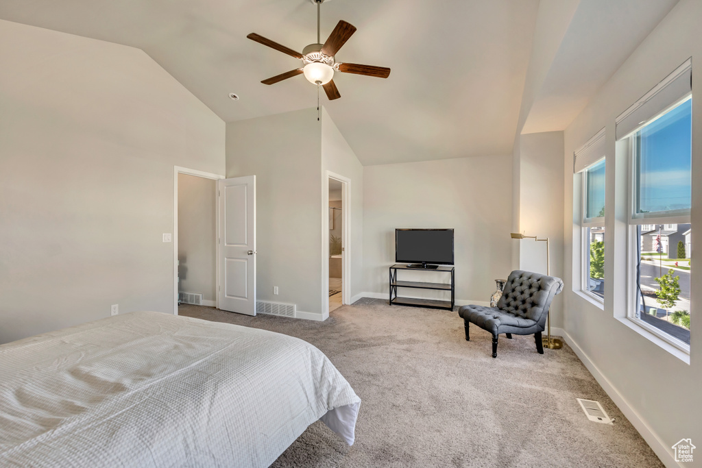 Bedroom with carpet flooring, baseboards, ceiling fan, and high vaulted ceiling