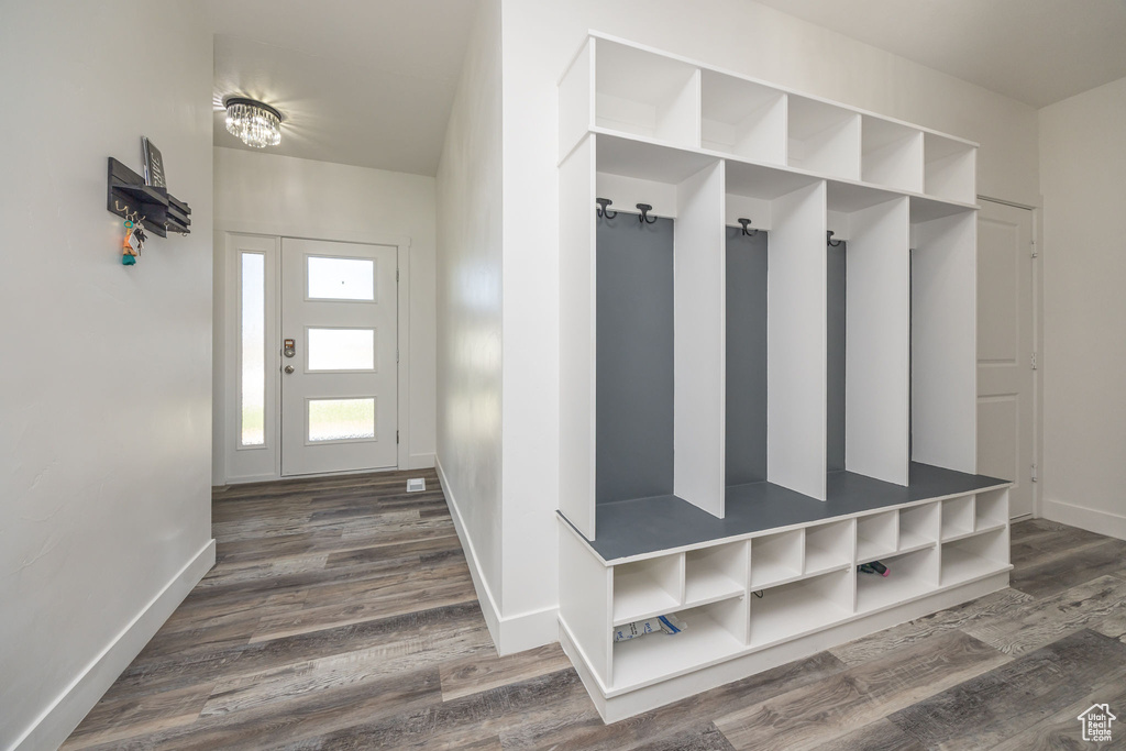 Mudroom featuring dark wood-style flooring and baseboards