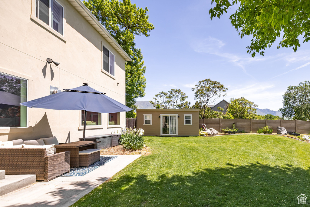 View of yard with an outdoor structure, an outdoor hangout area, and a mountain view