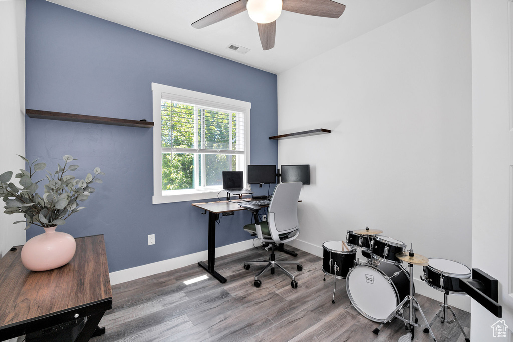 Office space featuring wood finished floors, ceiling fan, and baseboards