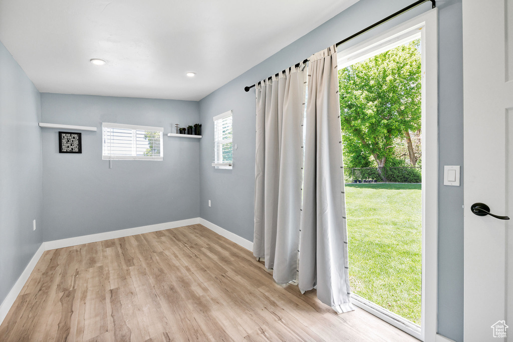 Spare room with light wood-style floors and baseboards