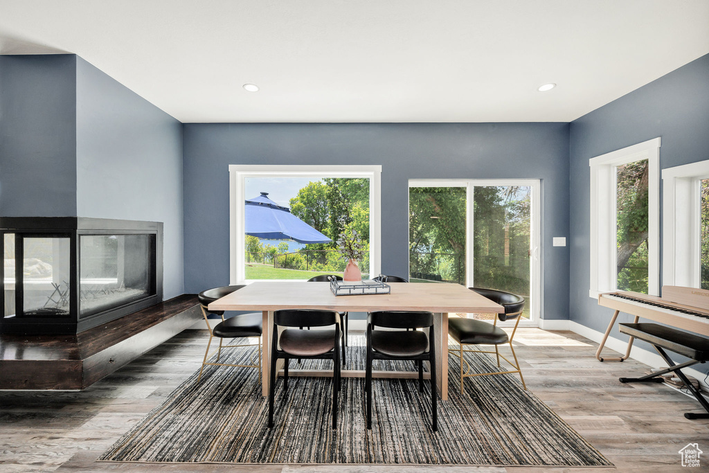 Dining space with wood finished floors, recessed lighting, and baseboards