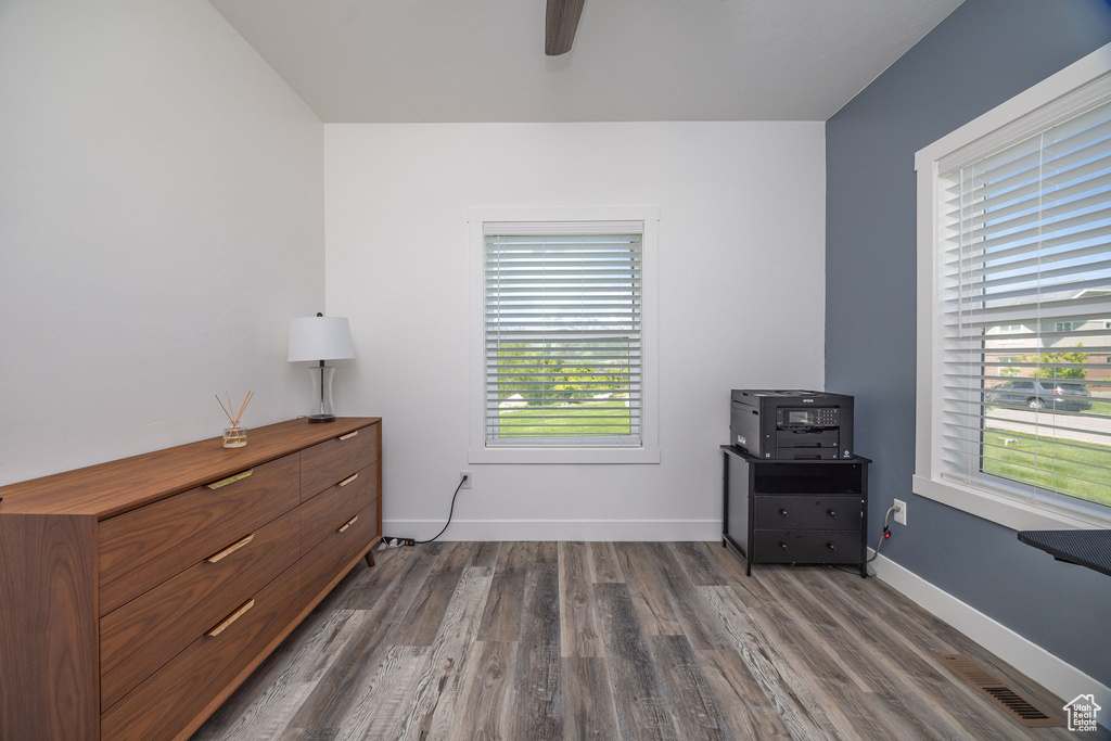 Bedroom with dark wood-style flooring, baseboards, and ceiling fan