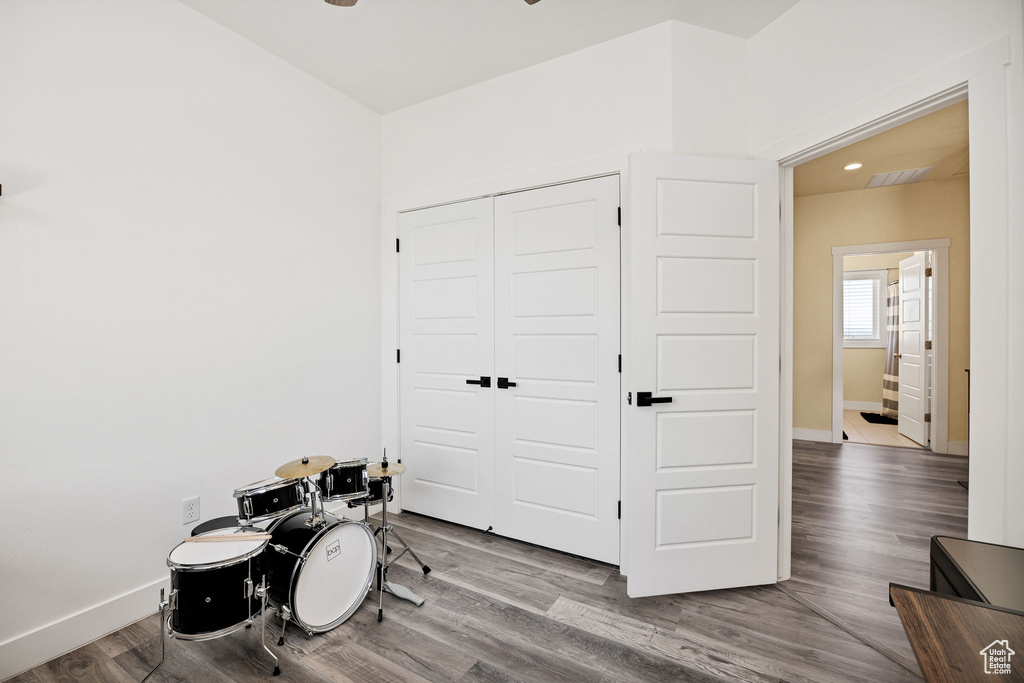 Game room featuring baseboards, wood finished floors, ceiling fan, and recessed lighting