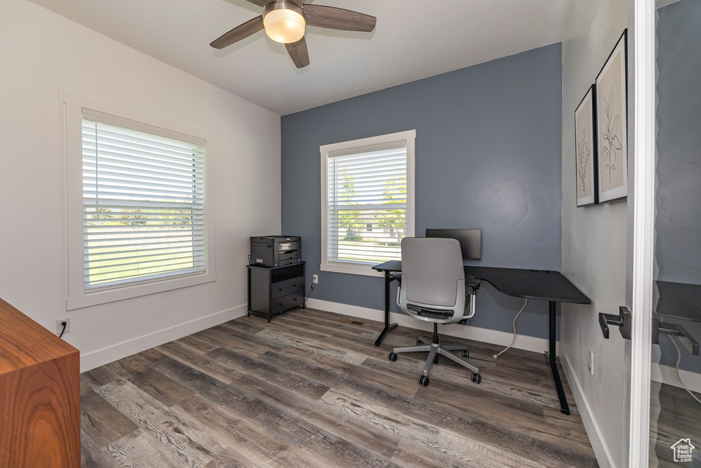 Home office featuring a ceiling fan, wood finished floors, and baseboards