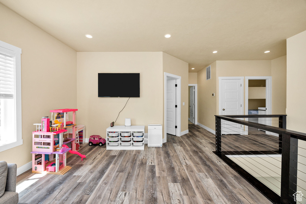 Rec room with wood finished floors, recessed lighting, and baseboards