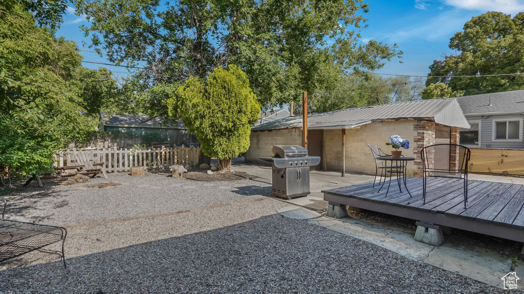 View of patio featuring a deck and a grill