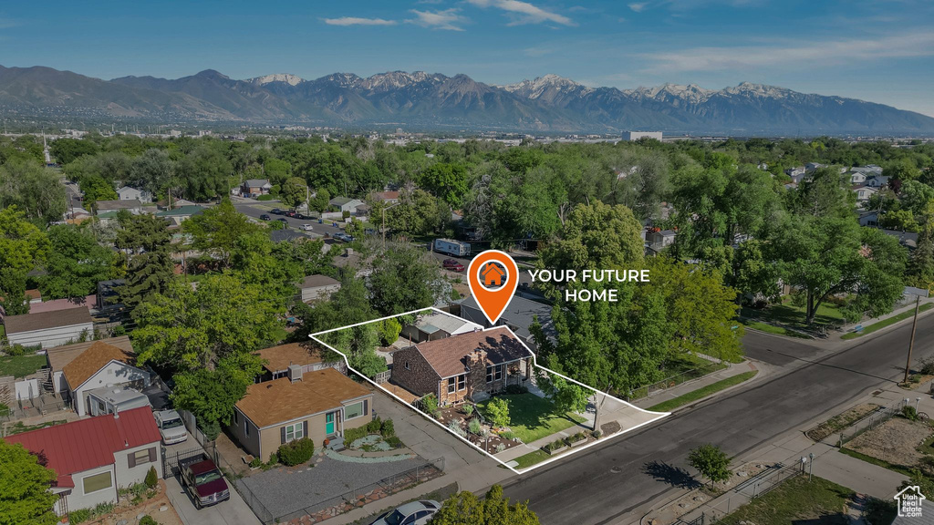 Aerial perspective of suburban area featuring a mountainous background and property boundaries highlighted