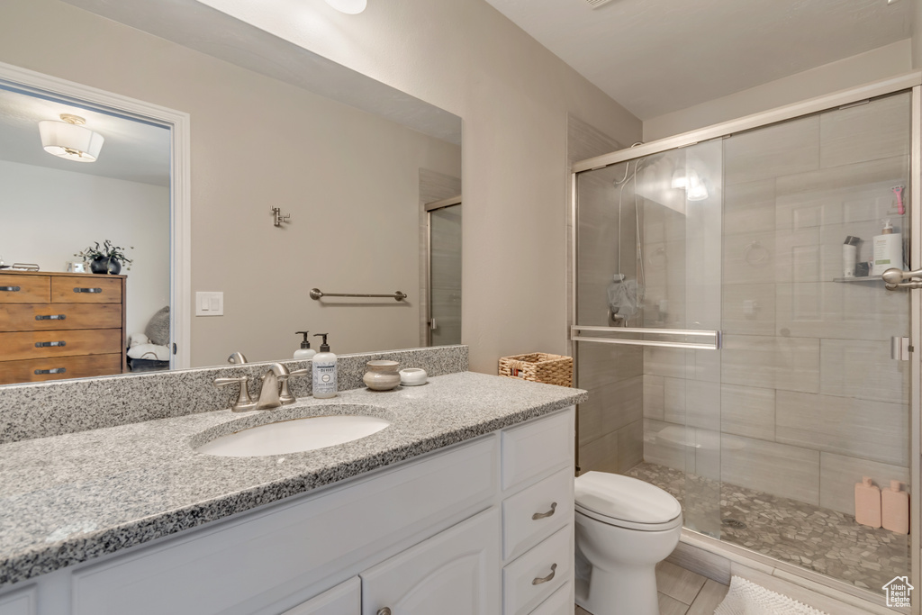 Ensuite bathroom featuring vanity, a stall shower, and toilet