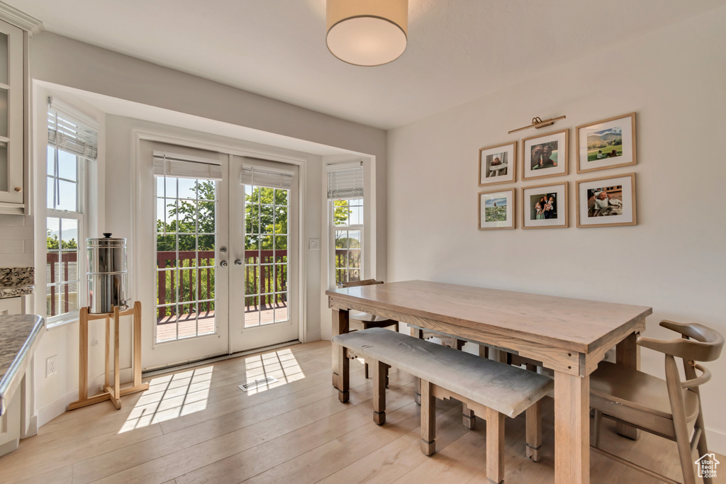 Dining area featuring french doors and light wood finished floors