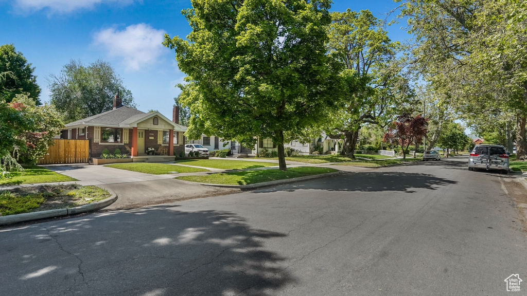 View of asphalt road with curbs and sidewalks