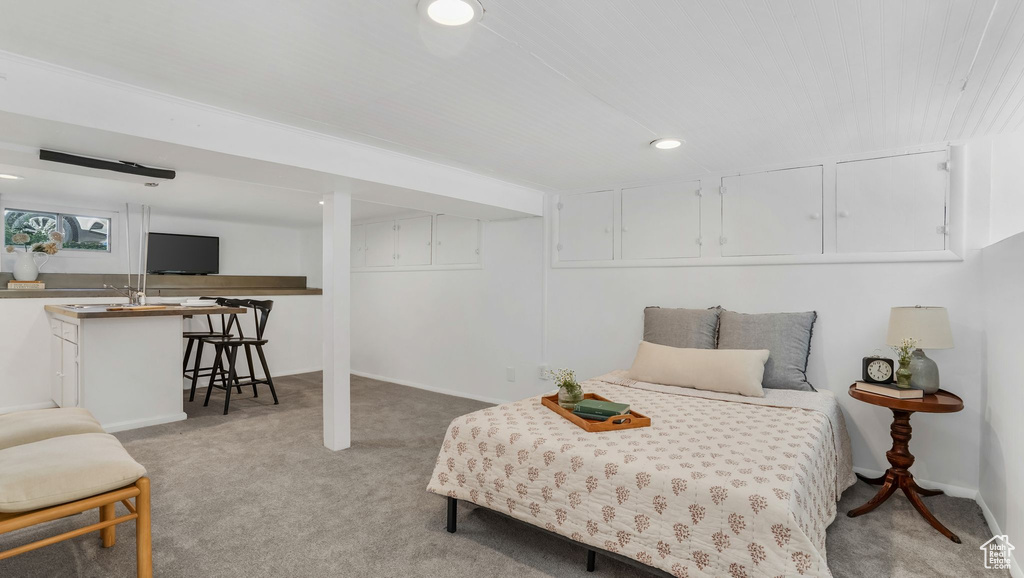 Bedroom with light colored carpet, recessed lighting, and baseboards