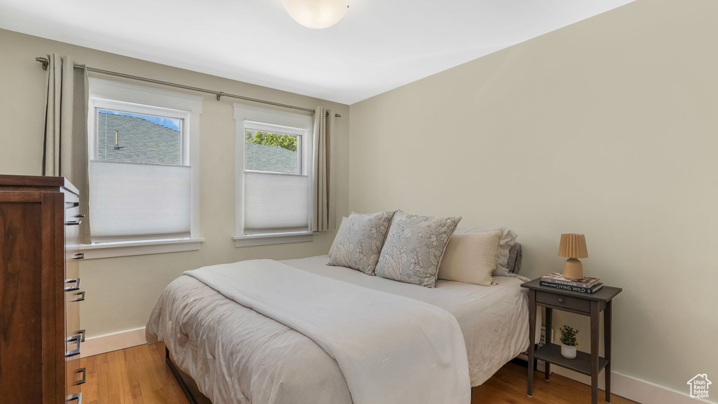 Bedroom featuring baseboards and wood finished floors