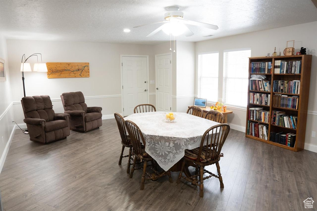 Dining area featuring baseboards, wood finished floors, a textured ceiling, ceiling fan, and recessed lighting