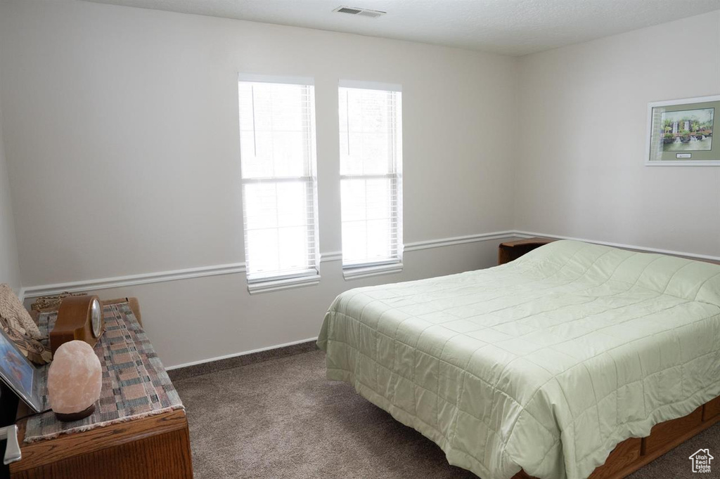 Bedroom featuring carpet floors and baseboards