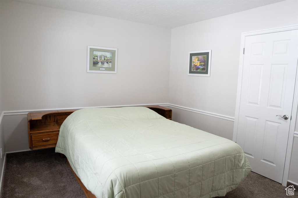 Bedroom with dark carpet