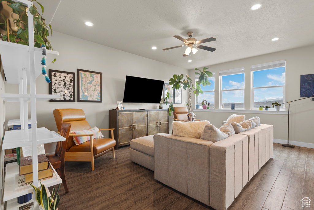 Living area with a ceiling fan, recessed lighting, wood finished floors, and baseboards