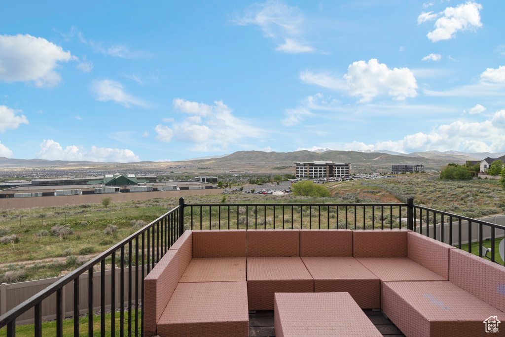 Balcony featuring a mountain view and outdoor lounge area