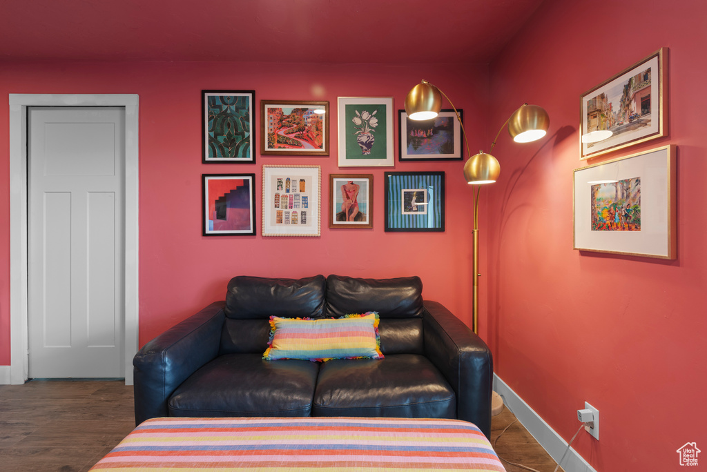Sitting room with baseboards and wood finished floors