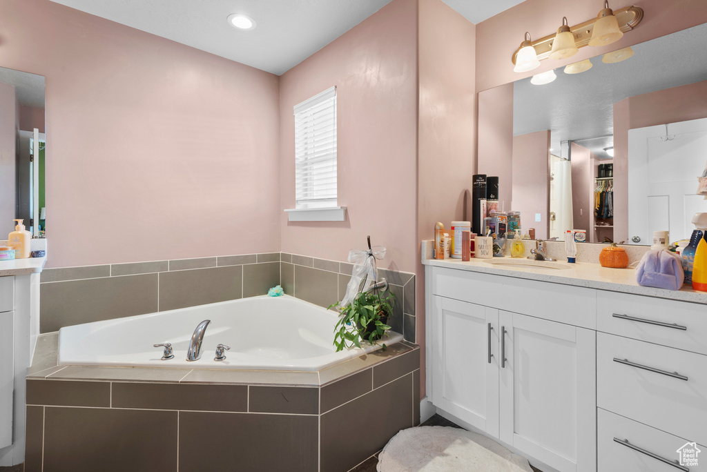 Bathroom with vanity and a bath