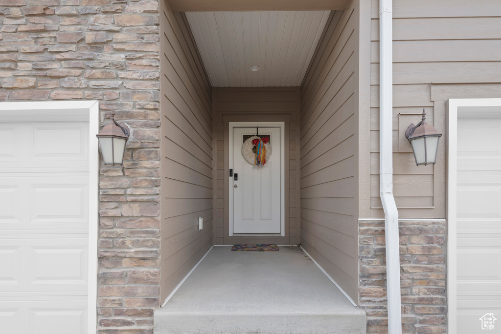 Property entrance featuring stone siding