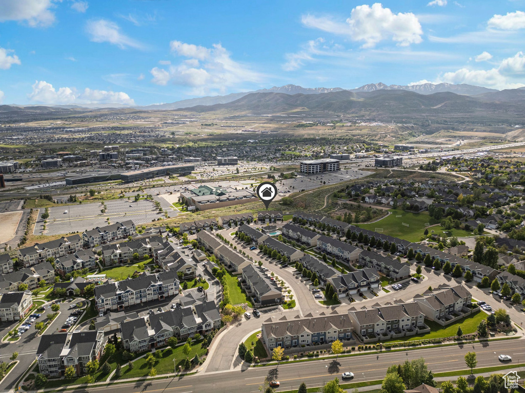 Aerial view of property\'s location featuring a mountainous background and nearby suburban area