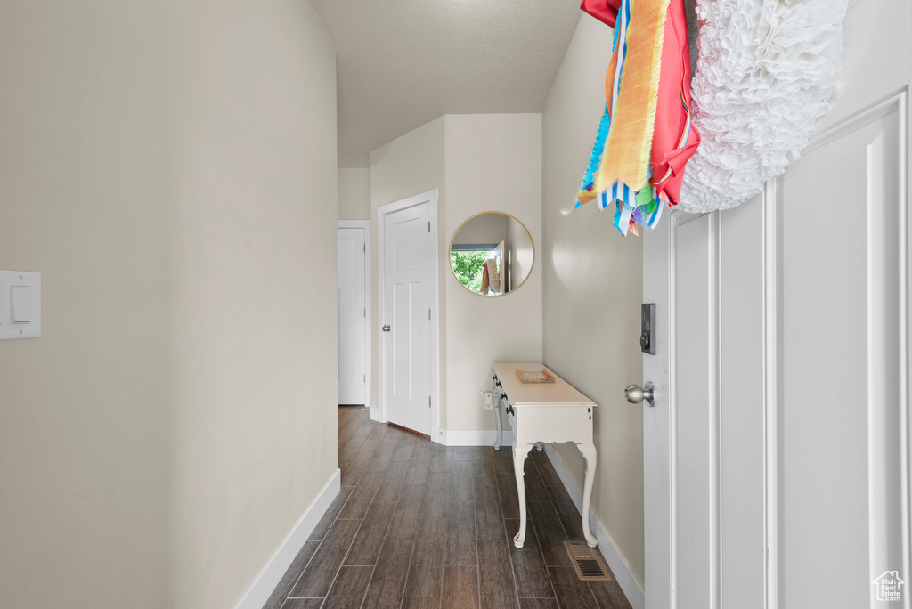 Foyer featuring baseboards and dark wood finished floors