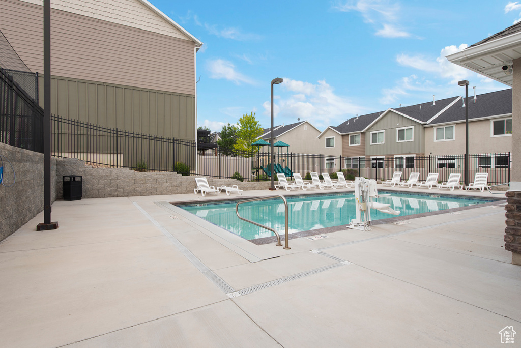 Community pool featuring a patio and a residential view
