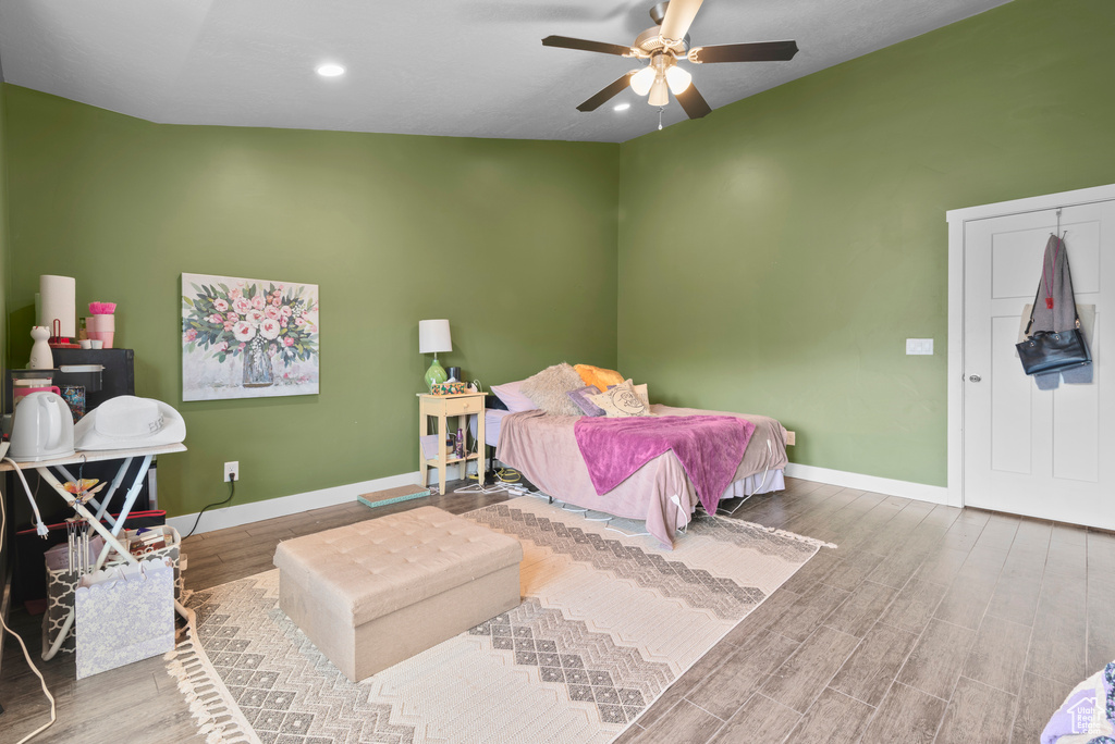 Bedroom featuring baseboards, wood finished floors, recessed lighting, and ceiling fan