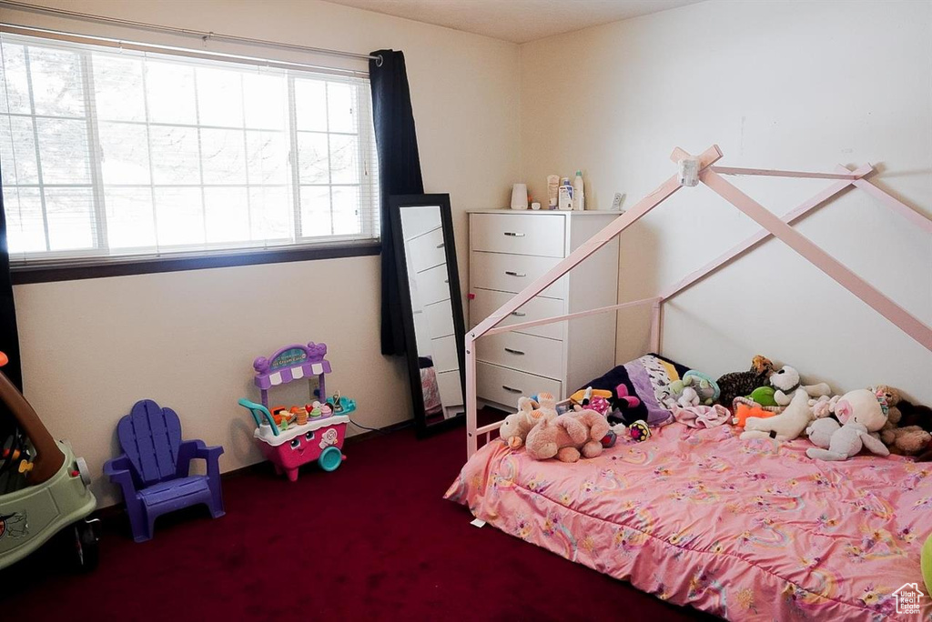 Carpeted bedroom with multiple windows