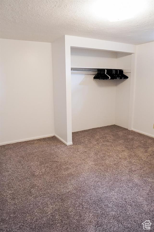 Unfurnished bedroom with carpet flooring and a textured ceiling