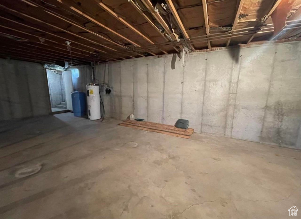 Unfinished below grade area featuring electric water heater