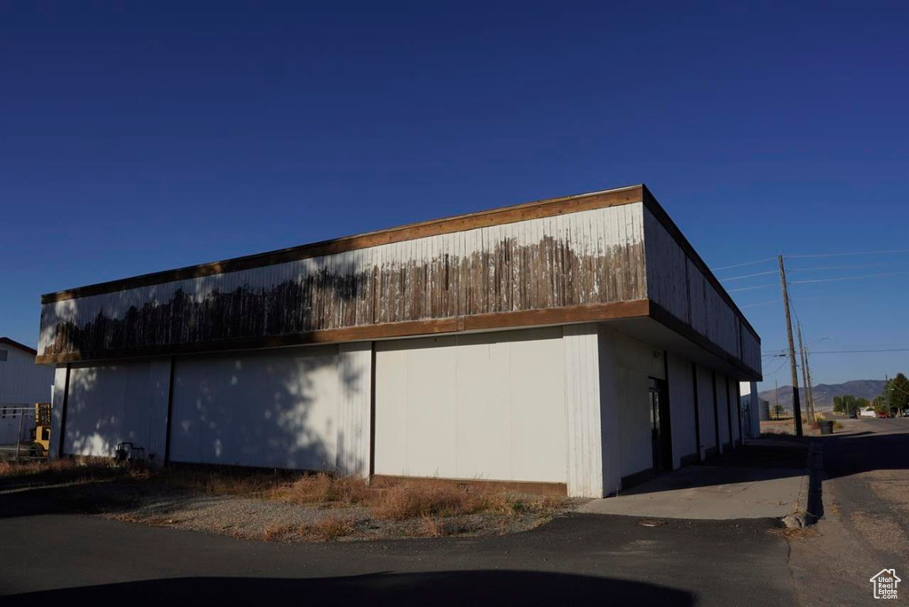 View of side of home with a detached garage