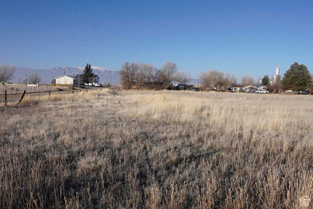 View of yard featuring a rural view and a mountain view